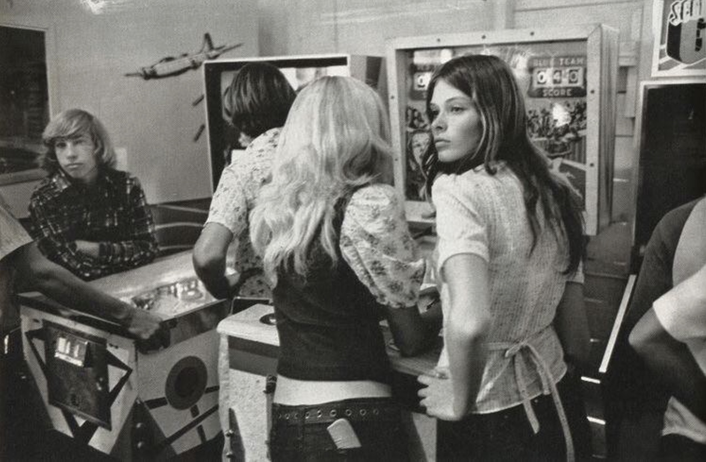 Teens hanging out at the arcade, 1976 